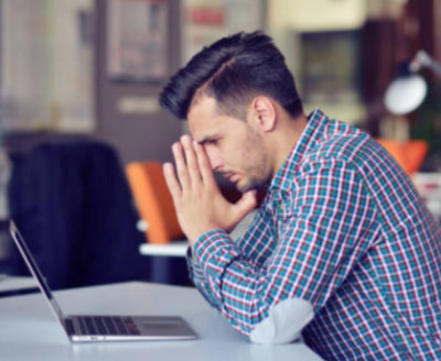 Frustrated man looking at a laptop screen